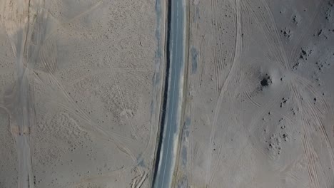Aerial-drone-shot-of-deserted-road-car-crossing-from-top-view-in-Mongolia